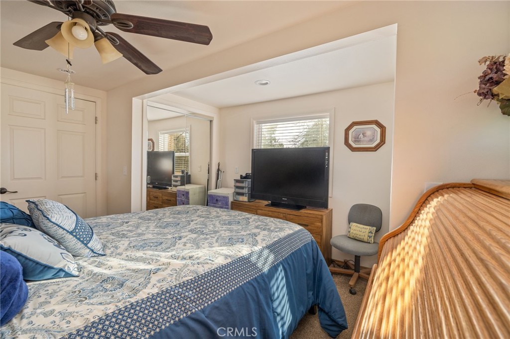 5072 Tip Top Road Mariposa, CA 95338 - Photo 15 of 41 a bedroom with a bed and a flat screen tv