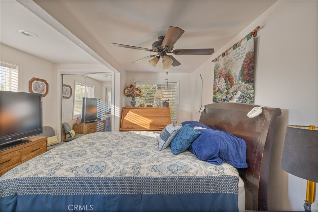 5072 Tip Top Road Mariposa, CA 95338 - Photo 16 of 41 a bedroom with a large bed and a flat screen tv