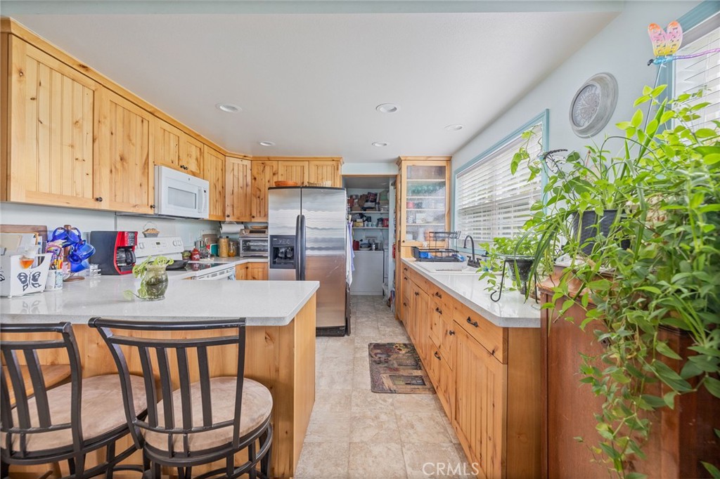 5072 Tip Top Road Mariposa, CA 95338 - Photo 2 of 41 a kitchen with stainless steel appliances kitchen island granite countertop a table chairs in it and wooden floor