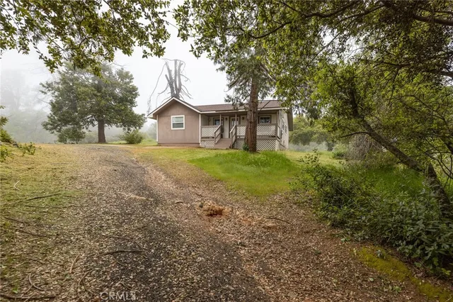 a big house with large trees and a big yard