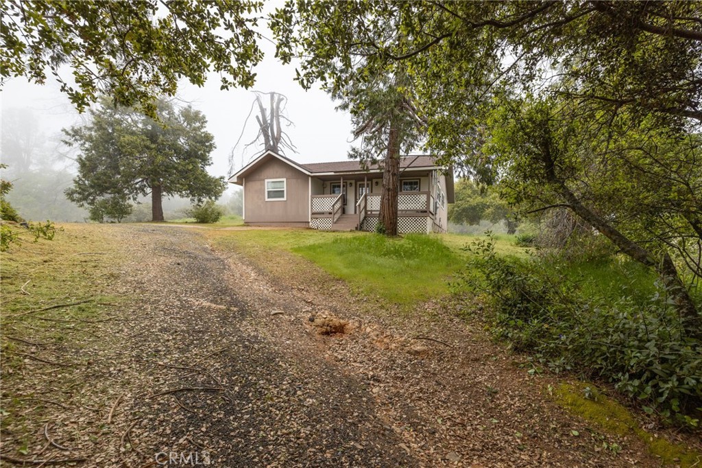 5072 Tip Top Road Mariposa, CA 95338 - Photo 37 of 41 a big house with large trees and a big yard