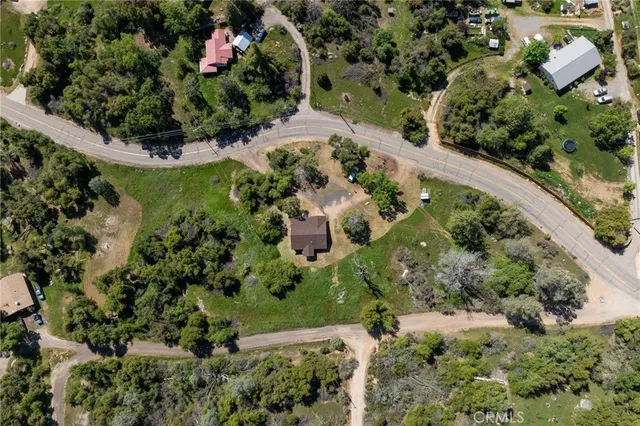 an aerial view of a house with a yard and garden