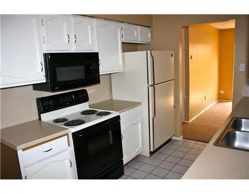 a kitchen with a stove and a refrigerator