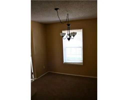 a view of a room with a windows and chandelier