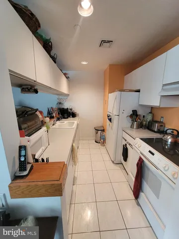 a kitchen with a sink a stove and cabinets