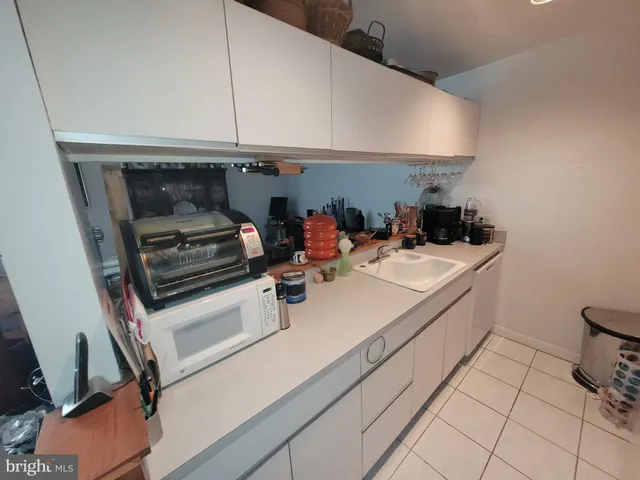 a kitchen with a sink and a stove top oven