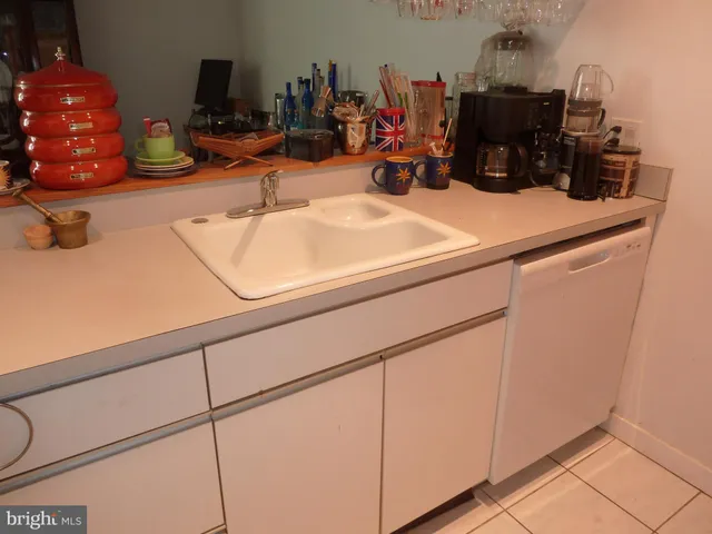 a kitchen with refrigerator a washer and dryer