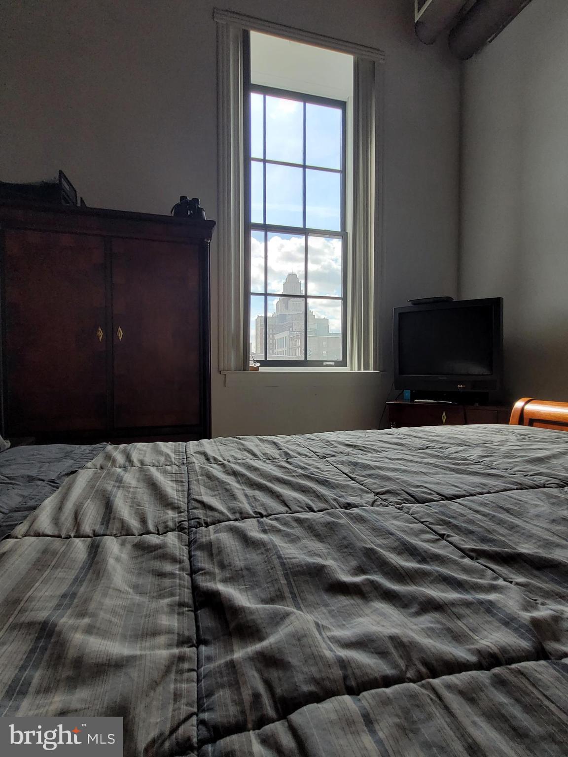 11 North 2nd Street, Unit 306 Philadelphia, PA 19106 - Photo 23 of 42 a bedroom with a bed and a flat tv screen