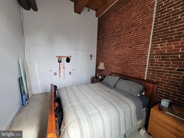 a bedroom with a bed and a mirror