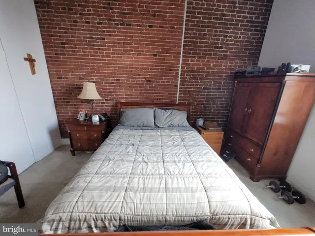 a bedroom with a bed and a mirror