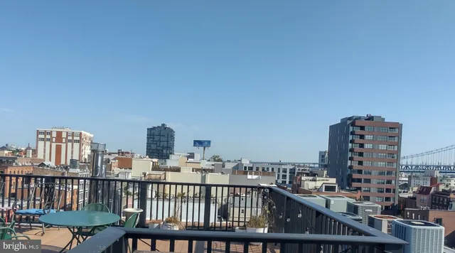 a view of a roof deck with two chairs and wooden floor