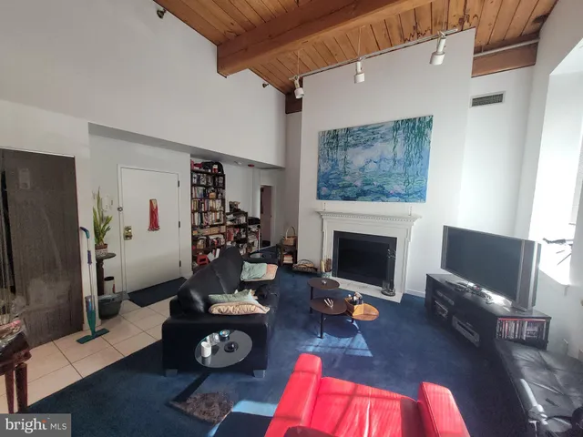 a living room with furniture fireplace and flat screen tv