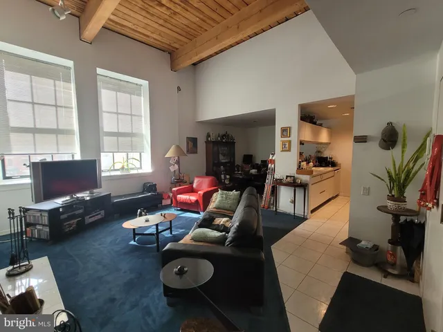 a living room with furniture chess table and a window