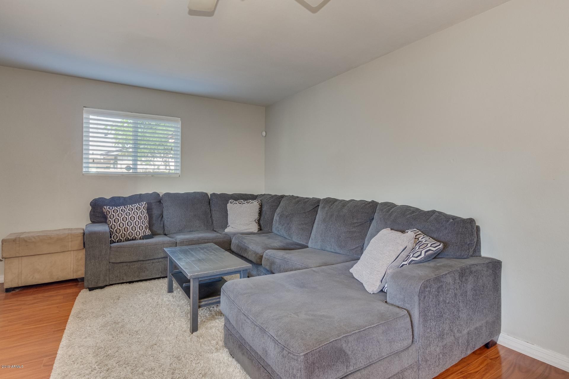 3129 West Cactus Road Phoenix, AZ 85029 - Photo 7 of 19 a living room with couches and a couch