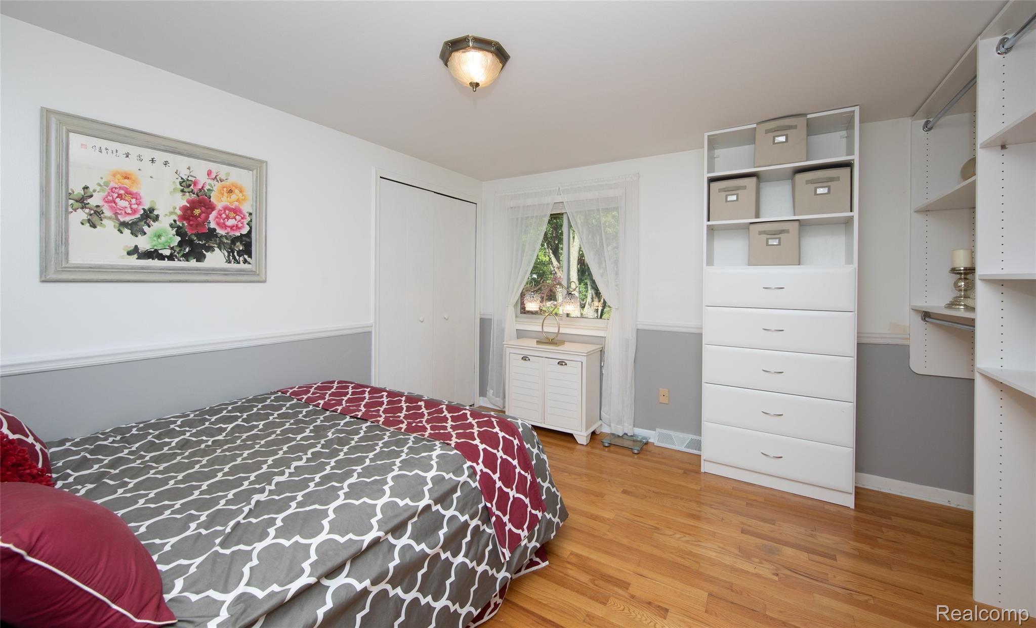 8117 Reese Road Clarkston, MI 48348 - Photo 35 of 41 Bedroom three has beautiful built in shelving and hardwood floors throughout.
