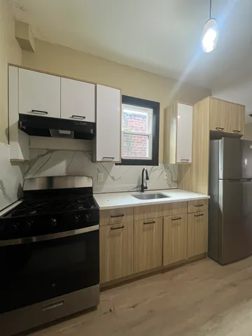 a kitchen with a sink and white cabinets