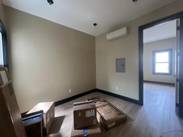 a view of a room with wooden floor