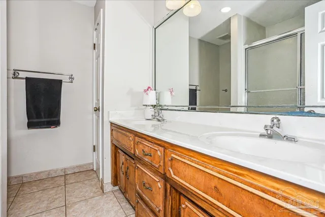 a bathroom with a double vanity sink and mirror