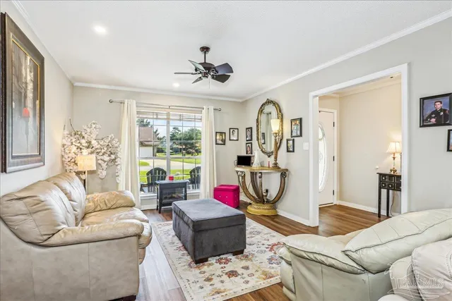 a living room with furniture a flat screen tv and a large window