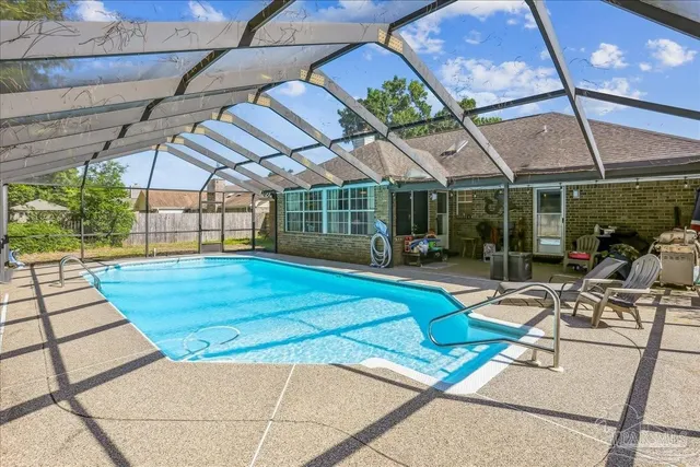 a view of a patio with a table and chairs under an umbrella
