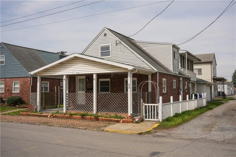 214 12th Street Monaca, PA 15061 - Photo 1 of 20 a front view of a house with a garden