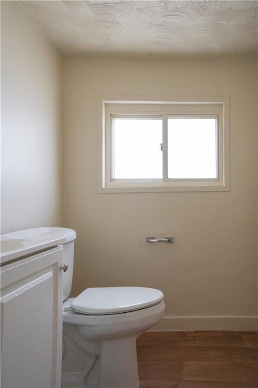 214 12th Street Monaca, PA 15061 - Photo 12 of 20 a bathroom with a toilet a sink a window and mirror