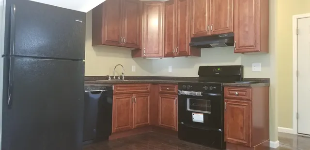 a view of hallway with wooden floor