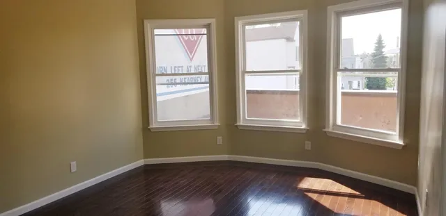 an empty room with wooden floor