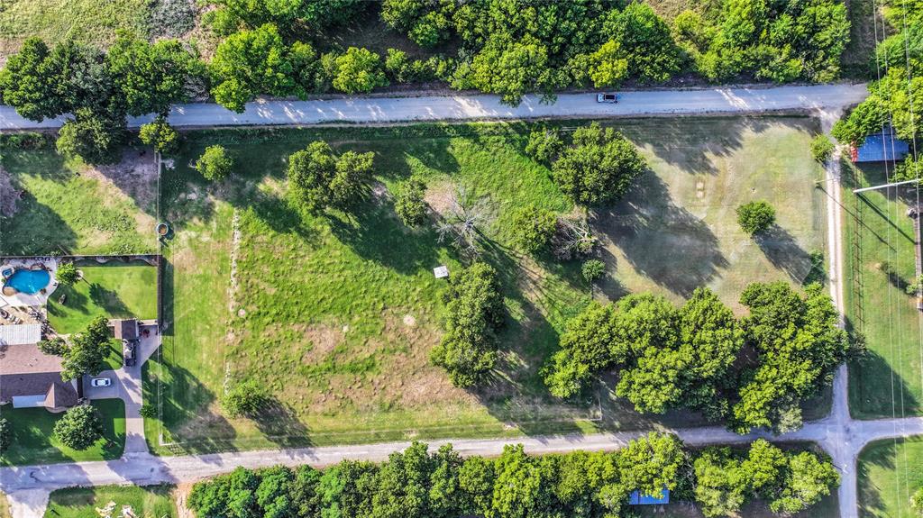 708 West Howell Street St. Jo, TX 76265 - Photo 2 of 14 an aerial view of a yard with plants and large trees
