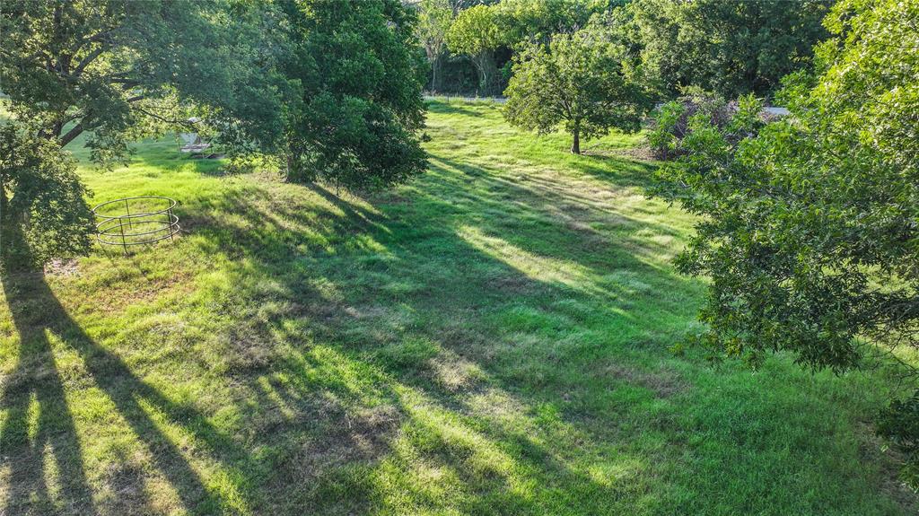708 West Howell Street St. Jo, TX 76265 - Photo 5 of 14 a big yard with lots of green space and trees