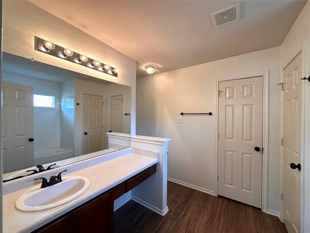 a bathroom with a bathtub and shower