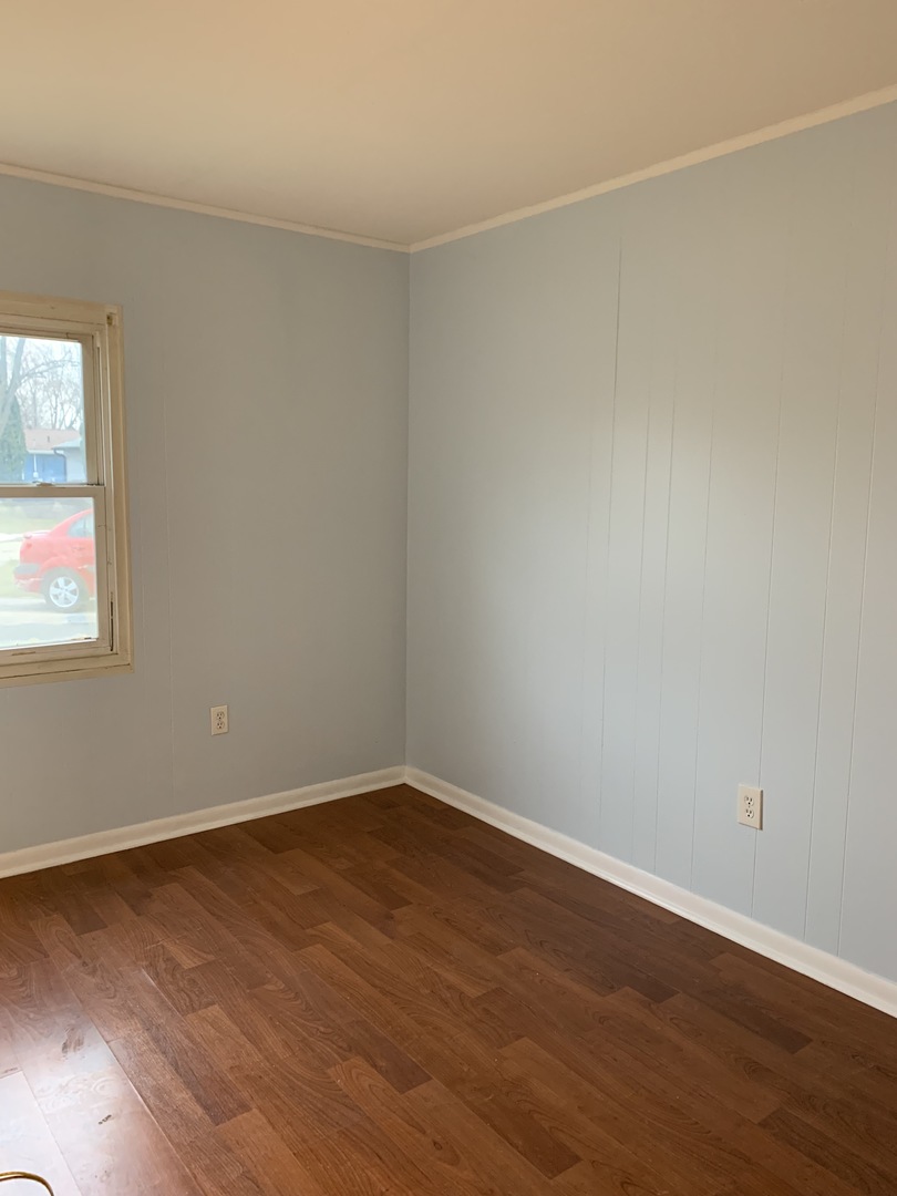 820 Post Lane Streamwood, IL 60107 - Photo 7 of 10 an empty room with wooden floor and windows