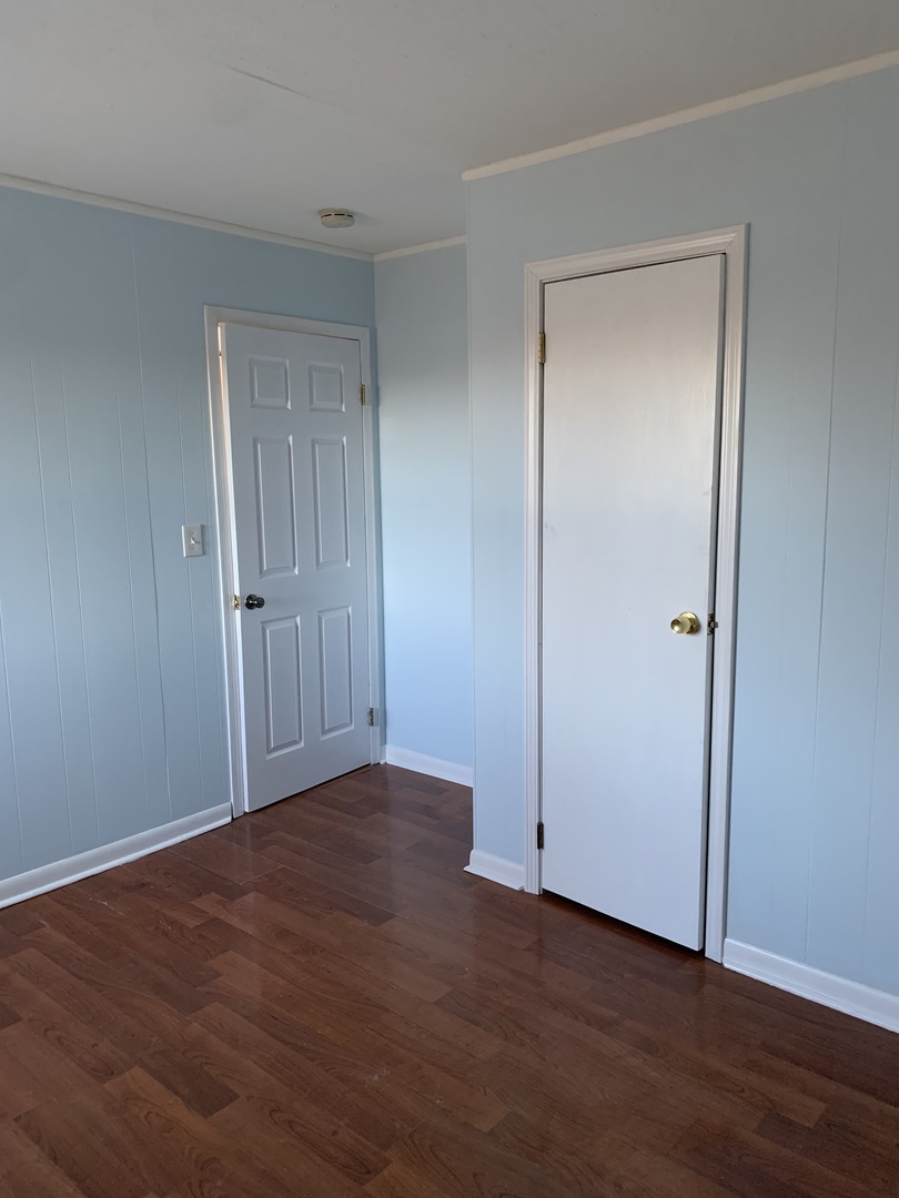 820 Post Lane Streamwood, IL 60107 - Photo 8 of 10 a view of an empty room with wooden floor