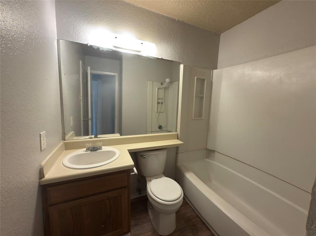 2250 Aspen Drive Dallas, TX 75227 - Photo 15 of 22 a bathroom with a sink toilet and shower