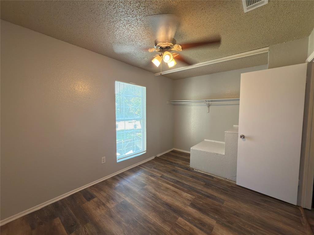 2250 Aspen Drive Dallas, TX 75227 - Photo 17 of 22 an empty room with wooden floor and windows