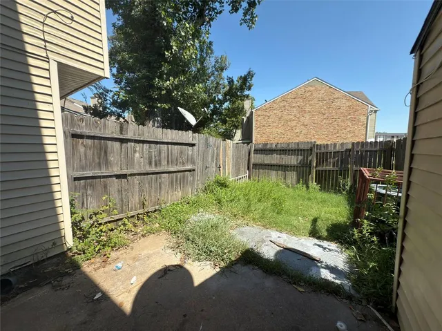 a view of backyard with plants and outdoor seating