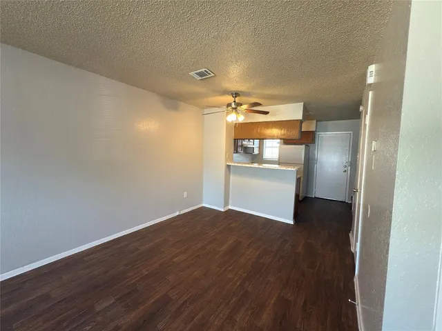 a view of a kitchen with wooden floor electronic appliances and kitchen