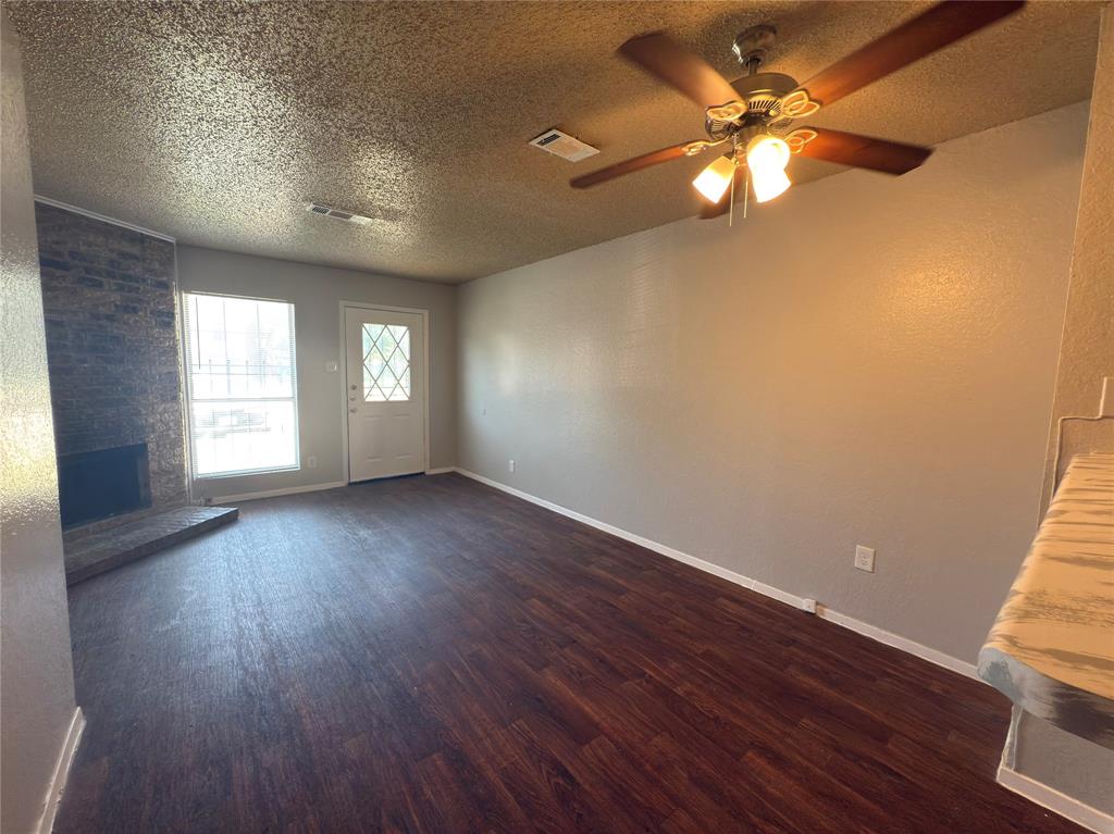 2250 Aspen Drive Dallas, TX 75227 - Photo 4 of 22 an empty room with wooden floor and windows