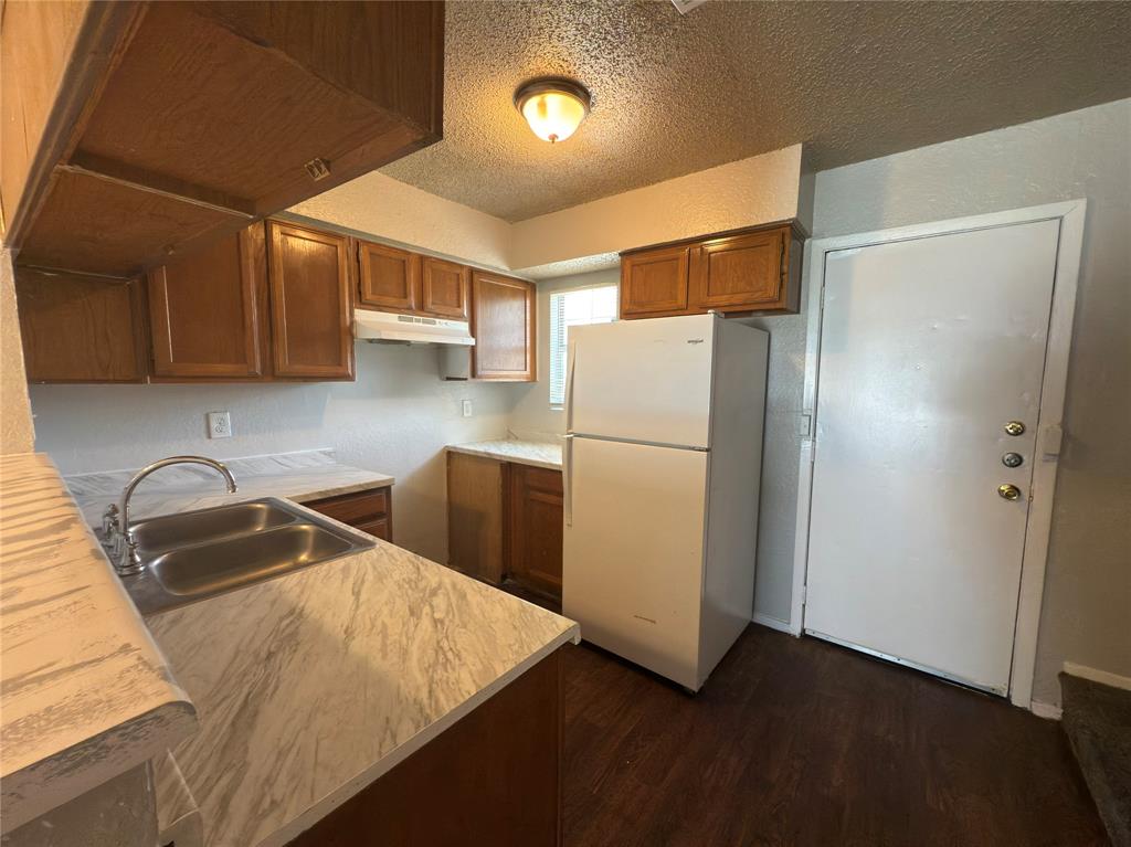 2250 Aspen Drive Dallas, TX 75227 - Photo 5 of 22 a kitchen with refrigerator and cabinets