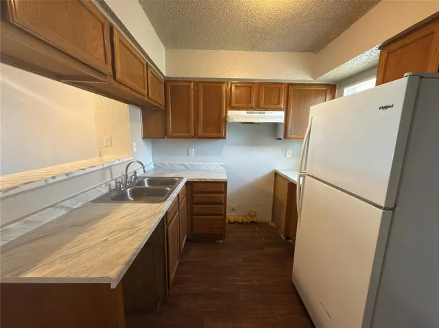 a kitchen with a refrigerator a sink and a stove