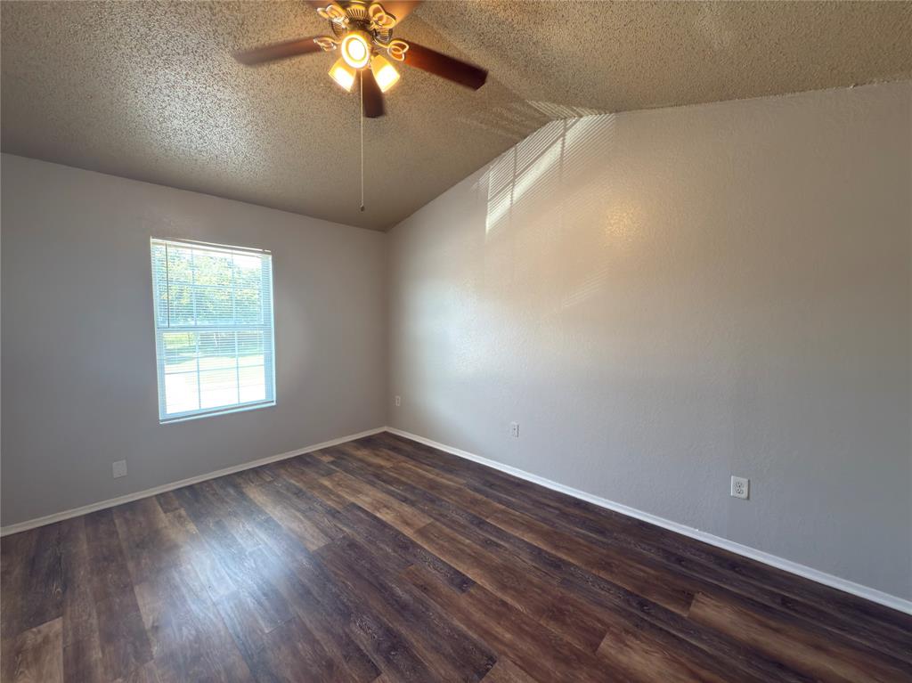 2250 Aspen Drive Dallas, TX 75227 - Photo 10 of 22 a view of an empty room with wooden floor and a window
