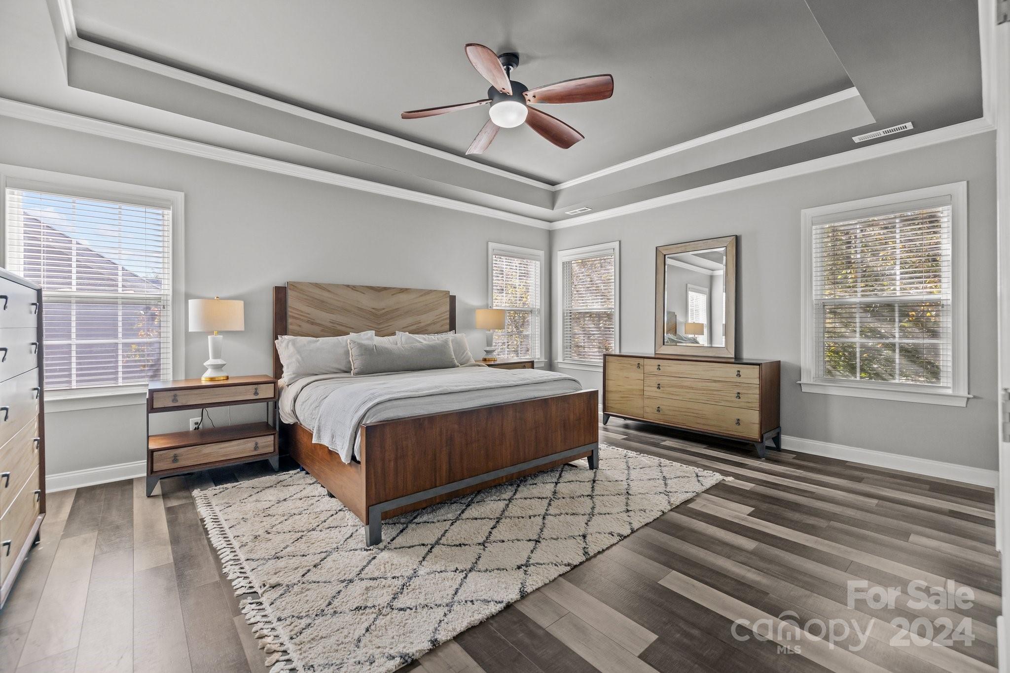 1106 Dove Trace Tega Cay, SC 29708 - Photo 15 of 38 a bedroom with a bed next to a window with a chandelier
