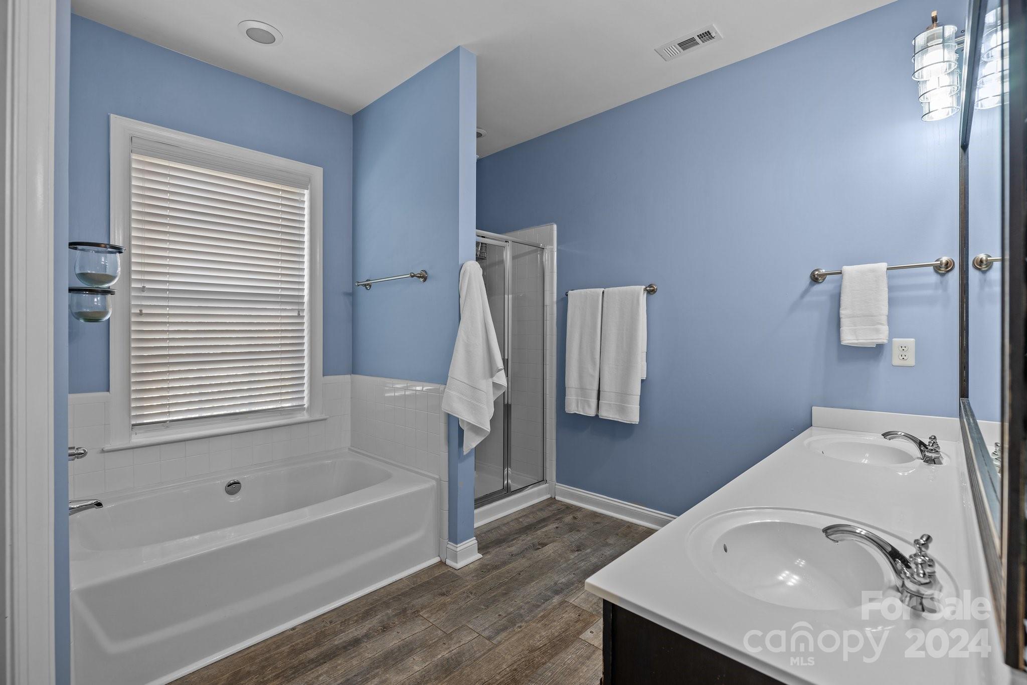 1106 Dove Trace Tega Cay, SC 29708 - Photo 16 of 38 a bathroom with a sink a bathtub and a shower