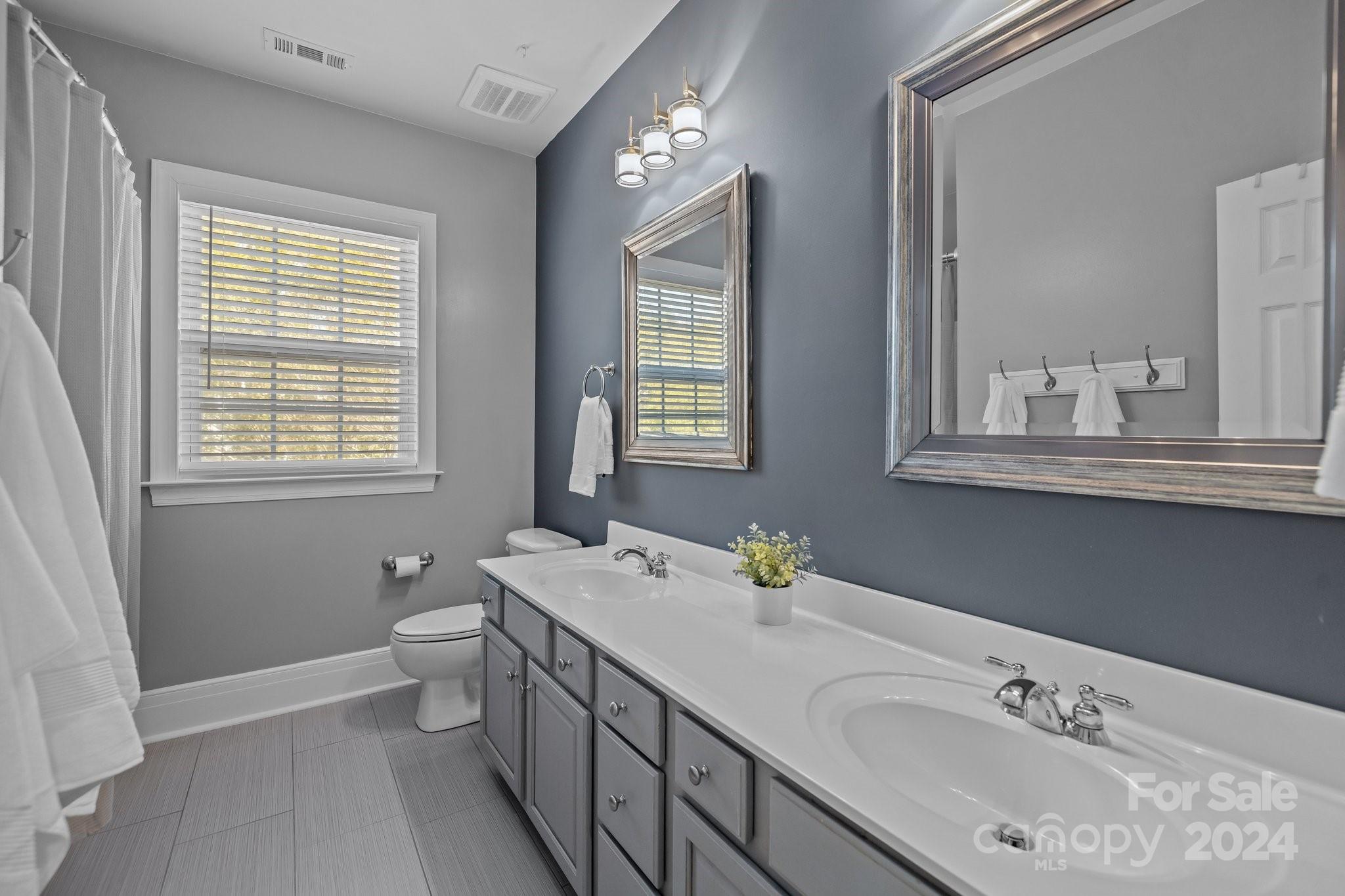 1106 Dove Trace Tega Cay, SC 29708 - Photo 22 of 38 a bathroom with 2 sink tub and a mirror