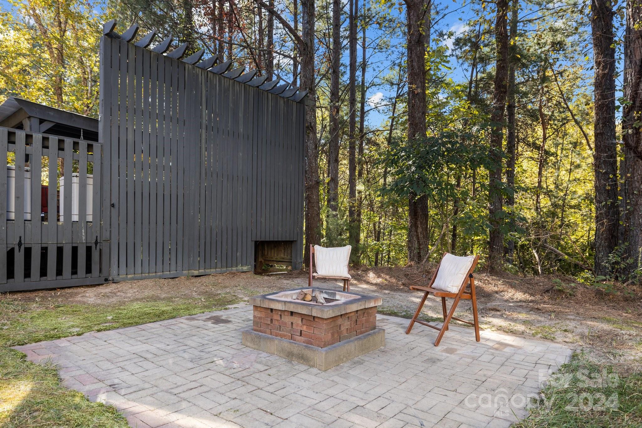 1106 Dove Trace Tega Cay, SC 29708 - Photo 30 of 38 a view of a chairs and table in backyard