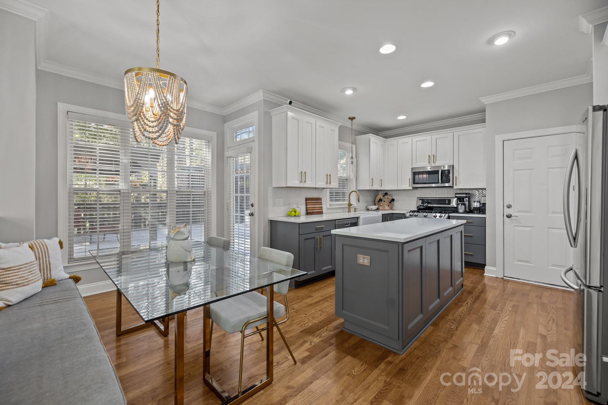 1106 Dove Trace Tega Cay, SC 29708 - Photo 6 of 38 a kitchen with granite countertop stainless steel appliances a sink a counter top space cabinets and wooden floor
