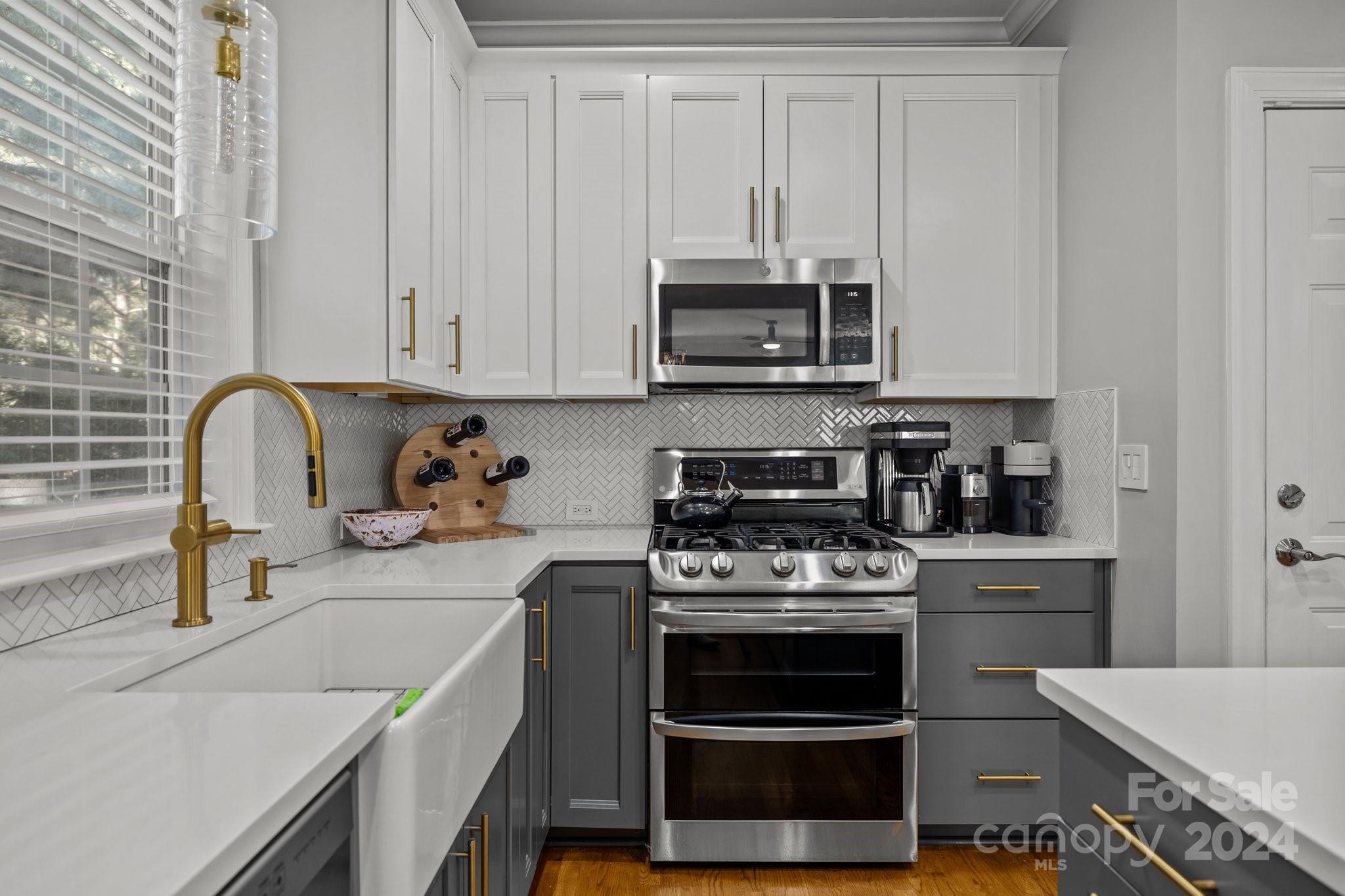 1106 Dove Trace Tega Cay, SC 29708 - Photo 9 of 38 a kitchen with stainless steel appliances granite countertop a stove and white cabinets