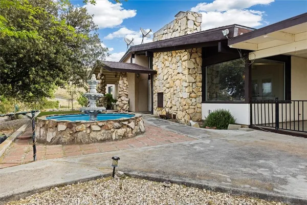 a view of a house with a small yard and floor to ceiling window