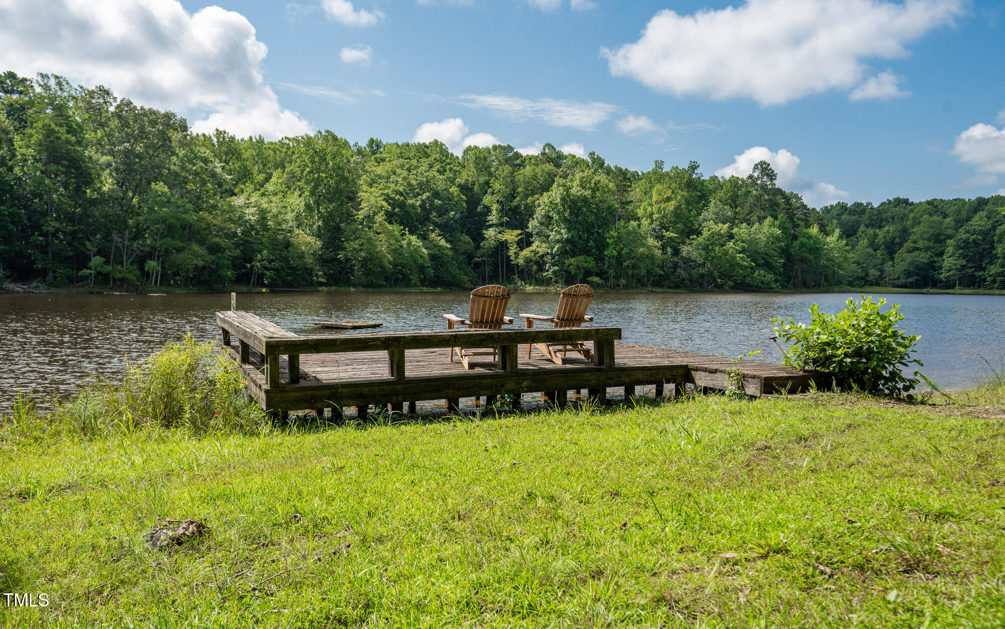 2918-3000 Chestnut Ridge Church Road Efland, NC 27243 - Photo 12 of 23 a view of a lake with outdoor seating area and trees in the background