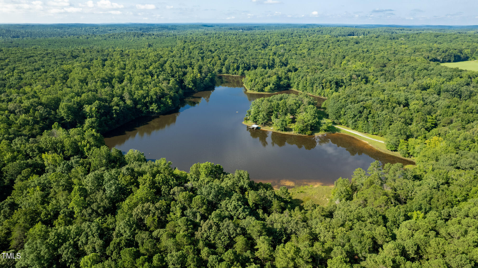 2918-3000 Chestnut Ridge Church Road Efland, NC 27243 - Photo 4 of 23 an aerial view of a house with a yard and lake view